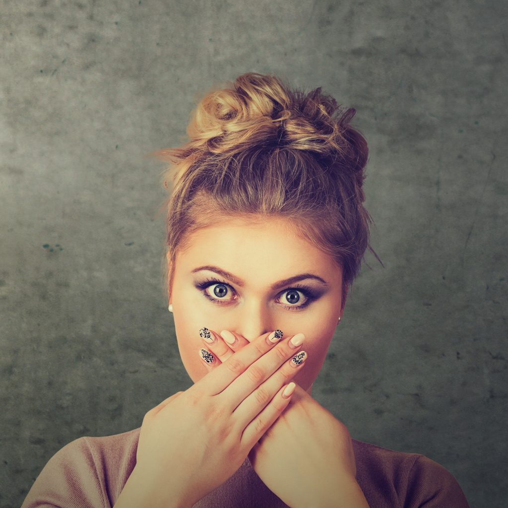 Group of multicultural women covering their mouth scared to speak out about abuse and domestic violence