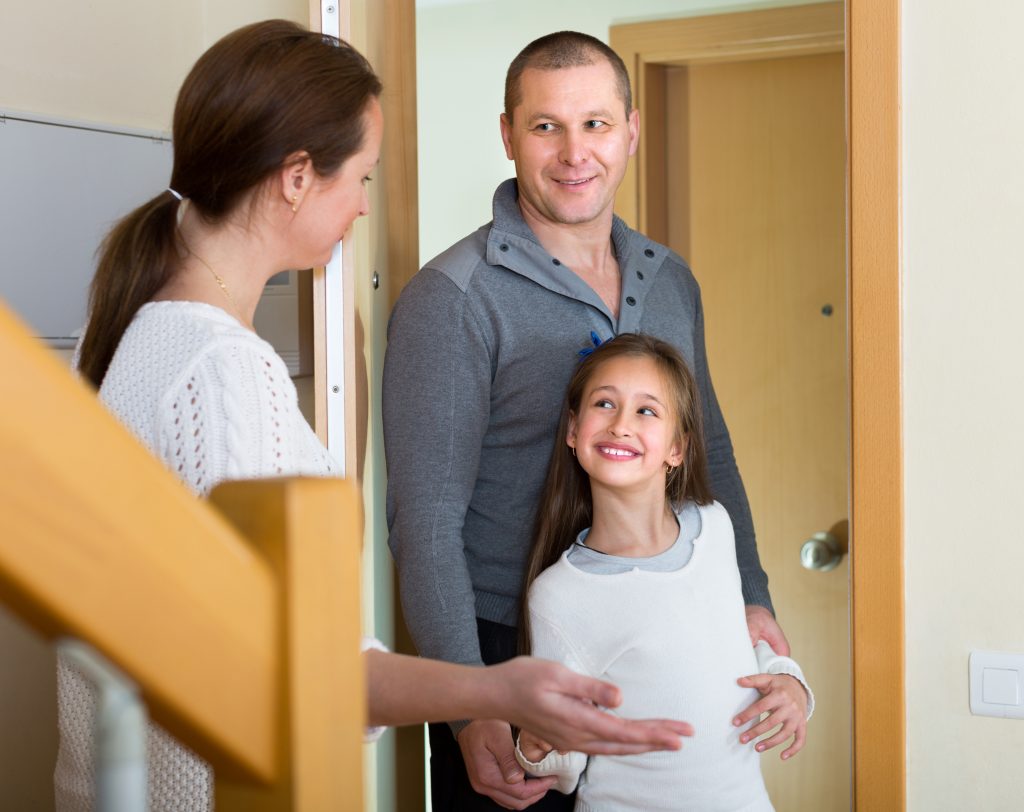 Couple with daughter at the doorway